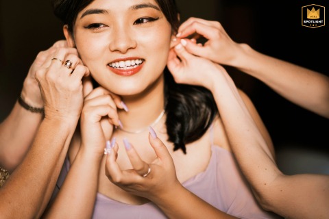 Bridal Prep: A Helping Hand for the Bride's Earrings Two girls helping a bride put on her earrings at La Posada in Santa Fe.