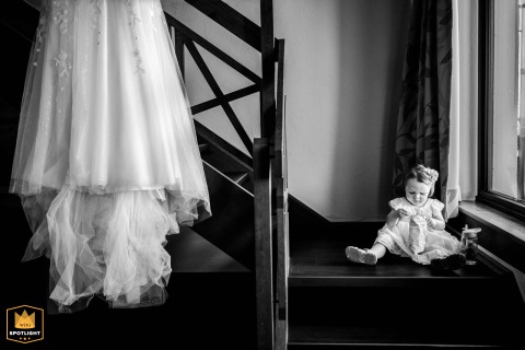 Daughter Catches Chips While Getting Ready For A Wedding At Gasthof Spelsberg Little daughter getting ready catches chips while sitting on the stairs at Gasthof Spelsberg, Altena, Sauerland, Germany.