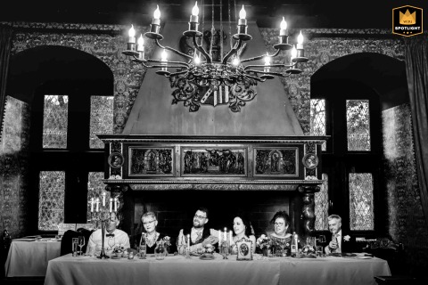 A German Castle Wedding: A Joyful Couple and Their Parents Share a Laugh Wedding at Schloss Friedewald, Germany: a joyful couple sitting at a table with their parents, sharing a laugh.