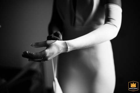Bridal Grace: A French Morning of Delicately Adorning Her Gloves in Her Parents' Room Bride getting ready, delicately putting on her gloves in her parents' room in France.