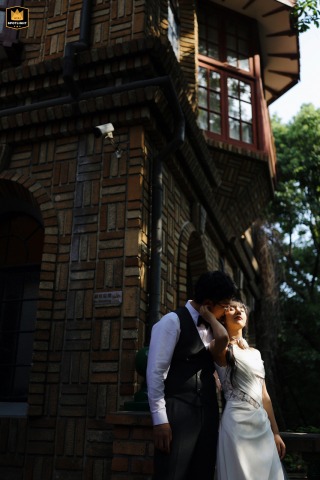 Tender Embrace at Shanghai's Moller Villa, Beautiful Light and Shadow Moller Villa, Shanghai. Tenderly embracing newlyweds in front of a vintage building, bathed in beautiful light and shadow.