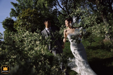 Strolling Hand-in-Hand Through the Woods at Zhouhai Garden Hotel in Shanghai Peaceful newlyweds stroll hand-in-hand through the woods at Zhouhai Garden Hotel in Shanghai, China.