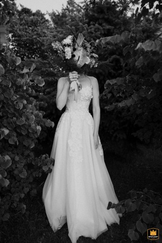 Polish Bride Posing in White Gown by the Hotel After Her Wedding Ceremony Polish bride in a white gown posing next to a hotel after her wedding ceremony.