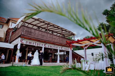 Wedding ceremony at Camelot venue, Budapest, Hungary, under dramatic sky and rustic wooden beams