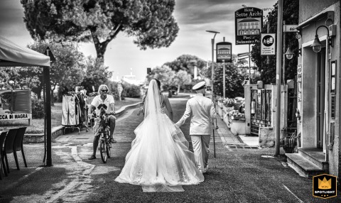 A Timeless Journey: A Bride And Groom In The Italian Town Of Bocca di Magra Black and white photo of a bride and groom walking away from the camera in the Italian town of Bocca di Magra.