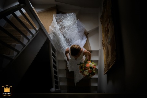 East Midlands Bride Gracefully Descends the Grand Staircase at Her Family Home East Midlands: A stunning bride, in her wedding dress, gracefully descends the staircase at her family home.