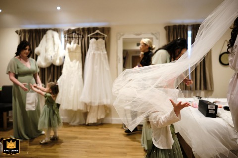 A Bride's Daughter Plays with Her Mother's Veil at the White Hart Inn The bride's daughter plays with her mother's veil as the bride gets ready for her wedding at the White Hart Inn in Derbyshire.