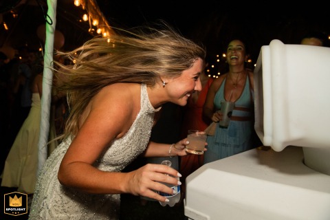 Capturing a Moment of Respite: A Bride’s Tranquil Dancefloor Cool-Down in Miramar A wedding photojournalist captures a bride cooling off during the dance at a reception in Miramar, Florida.