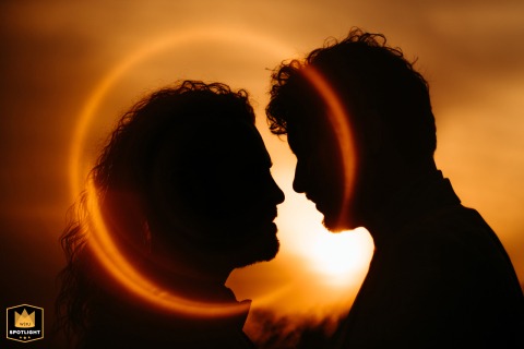 Sunset Silhouette: A "Ring of Fire" Portrait at the Gardens of Crystal Palace A wedding photojournalist captures a warm, silhouetted portrait of a couple at sunset, creating a "Ring of Fire" effect at the Jardins Palacio de Cristal in Porto, Portugal.