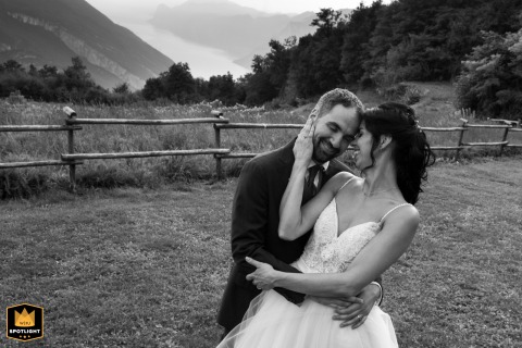 Bride and Groom’s Intimate Embrace at Their Reception in Trento After posing for a photo, a wedding photojournalist in Trento, Italy, captures an intimate hug of the bride and groom at their reception.