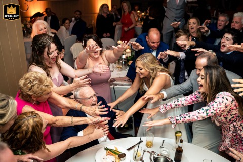 A Grandfather Beaming with Pride at His Grandson's Wedding Celebration Philadelphia, Pa. — A proud grandfather beams at The Inn at Woodloch as guests joyfully extend their hands to him in a moment of celebration.