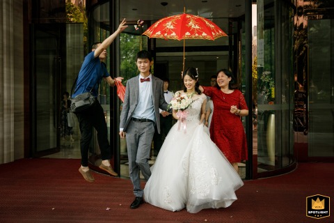 Elders Giving Candy to Newlyweds, A Traditional Shenzhen Wedding Custom An image captures a traditional custom in Shenzhen City, Guangdong Province, China. The image shows elders giving candy to a newlywed couple as they leave.
