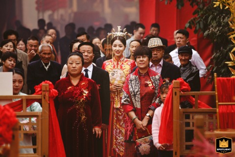 A documentary photograph captures a moment of anticipation at a Chinese wedding ceremony in Weinan City, Shaanxi Province. The image shows the bride preparing to make her grand entrance.