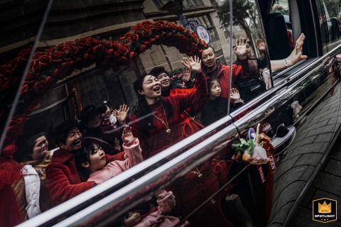 Bridal Farewell: A Documentary-Style Moment of Goodbyes in Fujian, China A documentary-style photograph captures a poignant moment as a bride says goodbye to her relatives and friends at a home in Fujian, China. The image portrays the emotional farewell before the wedding ceremony.