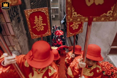 A documentary photograph captures a traditional Chinese wedding ceremony at a home in Fujian, China. The image shows the wedding procession and highlights the cultural significance of the event.