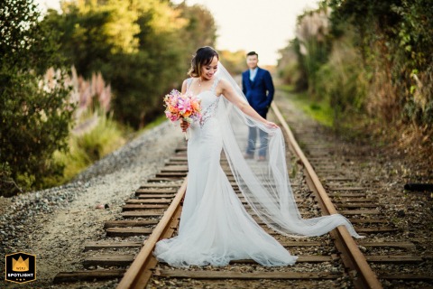 Happily Ever After, On The Tracks Of Love Wedding day portrait of the bride and groom on railroad tracks in Capitola, California.