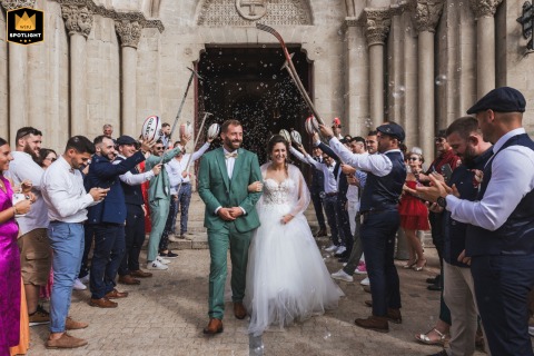 Bubble-Filled Exit in Landes, France, for the Happy Couple Wedding in Landes, France, as the couple exits a church surrounded by bubbles and a guard of honor.