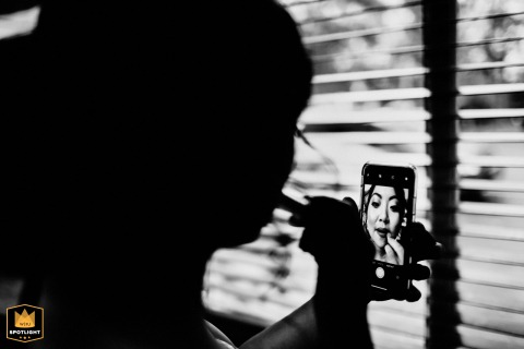 Saratoga Bride’s Silhouette: A Quiet Moment Before Forever, With Lipstick Silhouetted bride in Saratoga, CA, applying lipstick in mirror, a beautiful pre-wedding getting-ready moment.