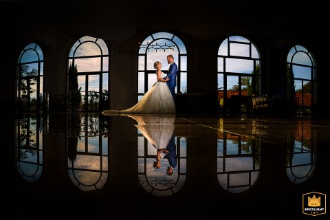 Tilleraie Reflections: A Romantic Chateau Portrait Before the Cocktail Hour A portrait of a couple is captured in the hall of Chateau La Tilleraie in Bergerac, France. The photograph shows the pair posing before the cocktail hour, with their reflection visible on the ground.