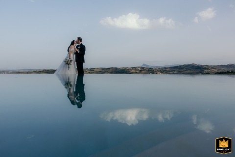 Kissing Couple Reflected With Historic San Leo Town Enchanting The Italian Background Reflection of a kissing couple in Italy, with the historic town of San Leo visible in the background.