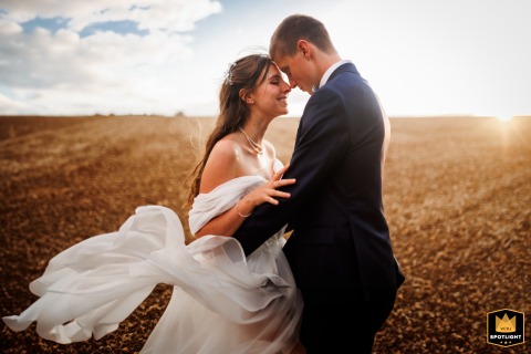 Charente, France Wedding: Romantic Couple’s Portrait Amidst Sunlit Fields Of Golden Dreams Charente, France wedding: A couple's photoshoot in a field, capturing a romantic portrait.