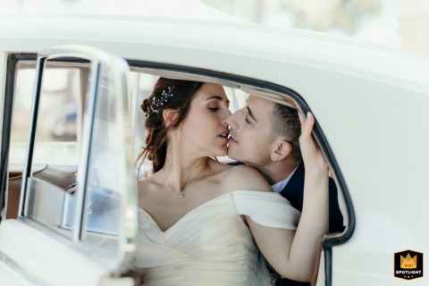 Newlyweds Kiss In Vintage Car After San Pietro In Campiano Church Wedding Newlyweds share a kiss inside a vintage car after their San Pietro in Campiano church wedding.
