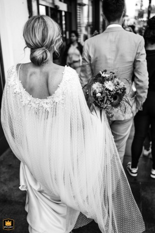 Just Married Couple Celebrates Wedding Strolling Hand-In-Hand Down Brixton’s Electric Avenue Just married couple strolls hand-in-hand down Electric Avenue in Brixton, celebrating their wedding day.