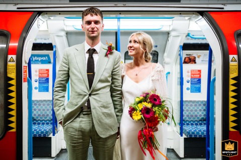 Couple Embraces For Wedding Portrait Amidst Iconic Brixton Station Architecture, London Underground Wedding portrait on the London Underground: a couple embracing amidst the iconic Brixton station's architecture.