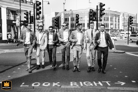 Groomsmen Stride In Unison Across Road At Lambeth Town Hall London Wedding Lambeth Town Hall, London: Groomsmen in suits stride across the road, looking right in a cohesive group shot.