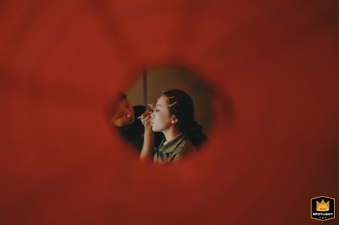 Peeking Through A Red Lantern: Bride Applies Makeup In Kaifeng, China Peeking through a red lantern, a bride puts on makeup in Kaifeng, China.