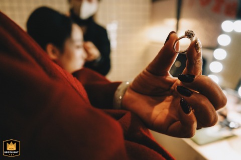 Bridal Preparations: A Daughter Adjusts Her Makeup, Her Mother Holds The Rings Bridal preparation in Kaifeng, China: the bride adjusts her makeup while her mother holds the wedding rings.