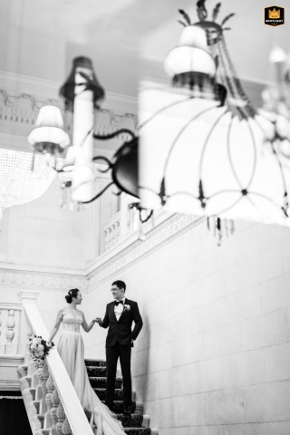 Bride and Groom Descending a Grand Staircase on Their Wedding Day Elegant Long Island wedding portrait: a bride and groom gracefully descend a grand staircase together.