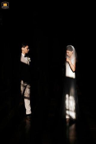 A Bride And Groom's Portrait At Hempstead House, Long Island, NY Hempstead House, Long Island, NY: Bride and groom stand in separate lit areas, a striking wedding portrait.