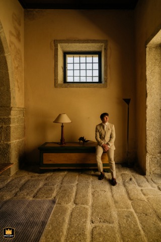 A Solitary Groom Awaits, Amares, Portugal Groom's solo portrait in a quiet, sunlit stone-floored room in Amares, Portugal.
