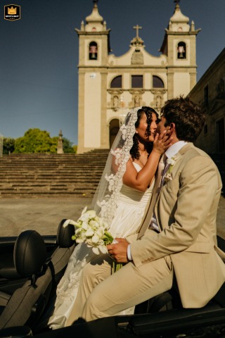 Majestic Kiss In Front Of A Building In Amares, Portugal The bride kisses the groom in front of a majestic building in Amares, Portugal.