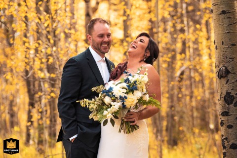 Happily Ever After Begins with Laughter in Lake Tahoe, California Just married couple in Lake Tahoe, California, already laughing with their arms wrapped around each other.
