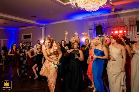 Game Face On: Barefoot Guest Leaps for the Bridal Bouquet Barefoot guest leaps to catch the bridal bouquet with a game face at Pen Ryn Estate in Philadelphia.