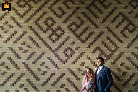 London Urban Chic: Formal Couple Portrait Against a Vibrant, Geometric Wall London, England, provides a stylish, urban setting for a couple's formal portrait as they stand together against a vibrant, geometrically patterned wall.