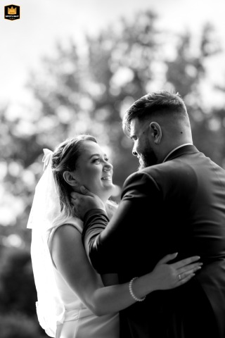 A Montreal Sunset Embrace: Newlyweds Gazing Deeply in Parc de la Visitation Parc Nature de l'Ile de la Visitation, Montreal, QC, Canada, provides a beautiful, natural setting where a newlywed couple stands close, gazing intently into each other's eyes in the magical light of the setting sun.
