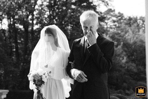 Poland: Emotional Father Wipes a Tear Before Walking Daughter Down the Aisle Poland, outside the church, is where the emotional father of the bride gently wipes a tear from his eye just moments before walking his daughter down the aisle.