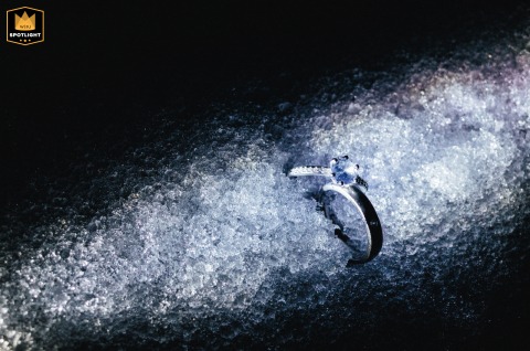 Brilliant Ring Catches Light in Ice and Snow on a Kaifeng Winter Day A wedding ring is featured in the foreground, catching the brilliant light and shadow of ice and snow during a winter day in Kaifeng, China.