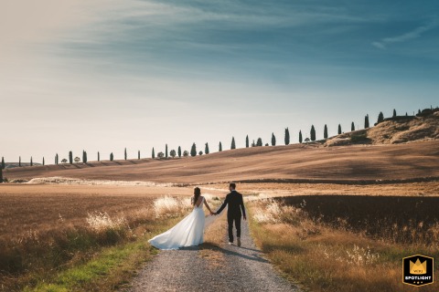 Romantic Portrait Amidst the Breathtaking Rolling Landscape of Crete Senesi In the breathtaking rolling landscape of Crete Senesi, Tuscany, the newly married couple is captured in a beautiful and romantic formal portrait amidst the iconic Italian countryside.