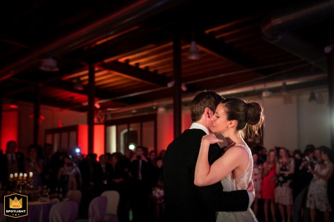 Trieste Wedding Reception: Bride and Groom Share an Intimate First Dance The joyful bride and groom share their first dance as a married couple, moving intimately across the floor at their reception venue in Trieste, Italy.