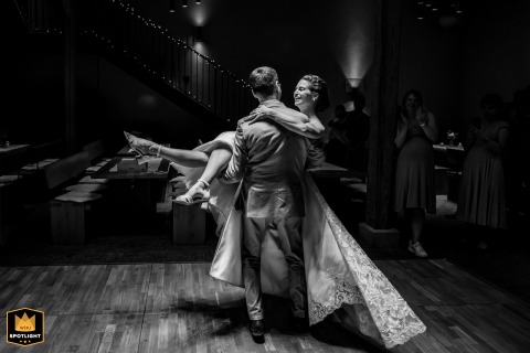 At the Wasem Kloster Engelthal in Ingelheim, Germany, the groom artfully lifts the bride high during their wedding opening dance, captured in a nostalgic black-and-white photograph.