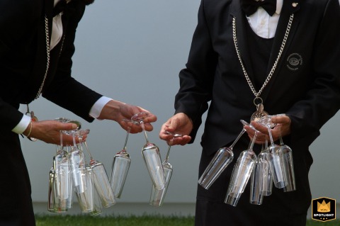 At Casa di Papi in Lazise, Verona, Italy, a clean, bold detail shot highlights sommeliers carefully preparing the aperitivo, showcasing their skillful hands and elegant glassware as they set the stage for elegant celebration.