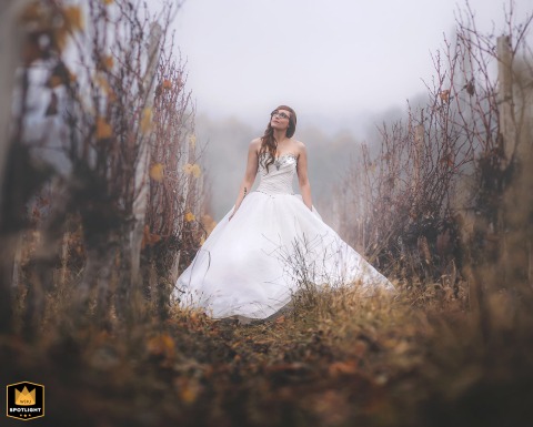   The bride stands alone in the grapefruit fields of Bergerac, Dordogne, France, her dress and the autumn scenery creating a display of seasonal beauty.