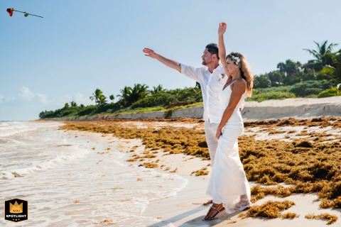   During the ceremony in Tulum, a symbolic offering is made to the goddess of the ocean, illustrating spiritual themes and connections to nature within the wedding celebration.