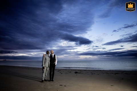   On the golden sands of Whitely Bay, Tyne & Wear, UK, a couple shares a romantic session at sunset, surrounded by the tranquil beauty of the shoreline.
