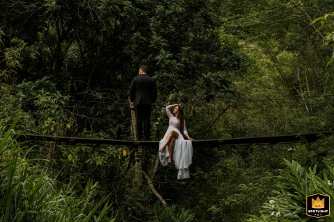  An intimate couple portrait from São Paulo captures the newlyweds together on a hanging foot bridge in the woods.