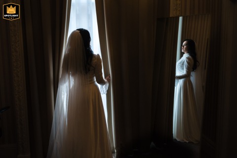 Window Light Accentuates A Striking Bridal Portrait At Columbia Hotel In London At Columbia Hotel in London, a striking bride portrait showcases her in wedding dress, highlighted by the window light at this classic London venue.